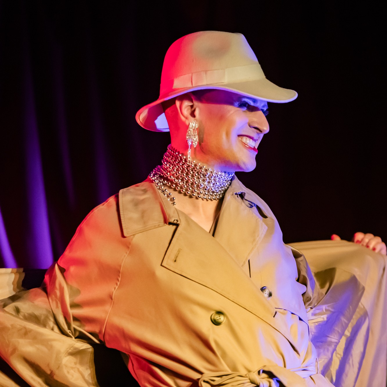 Roylesque as the inspector removes the trench coat to reveal another trench coat underneath.